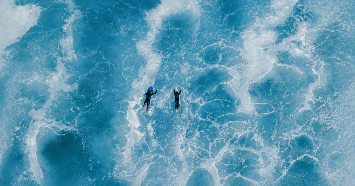 End of Summer Sale – two surfers paddling through turquoise waves